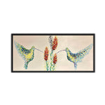 A canvas oil painting of two hummingbirds with floral elements, predominantly in bright colors set against a light background.